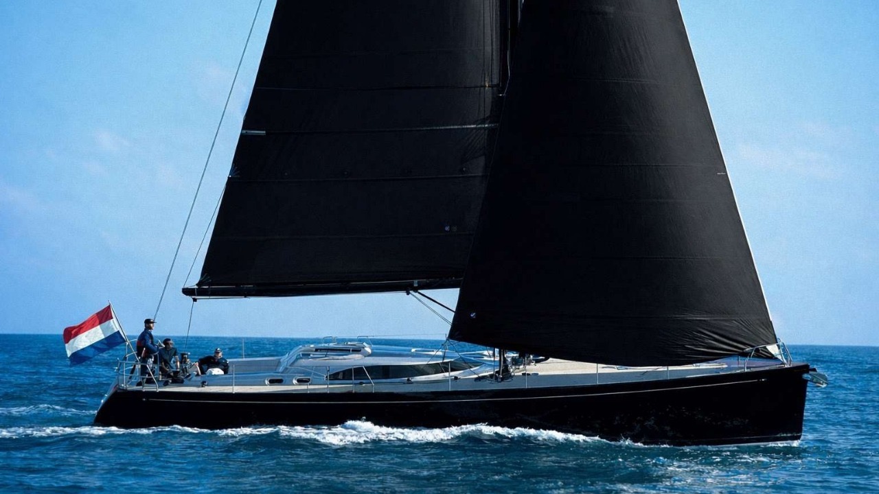 Gemini 52 Med under full black sails in the Mediterranean